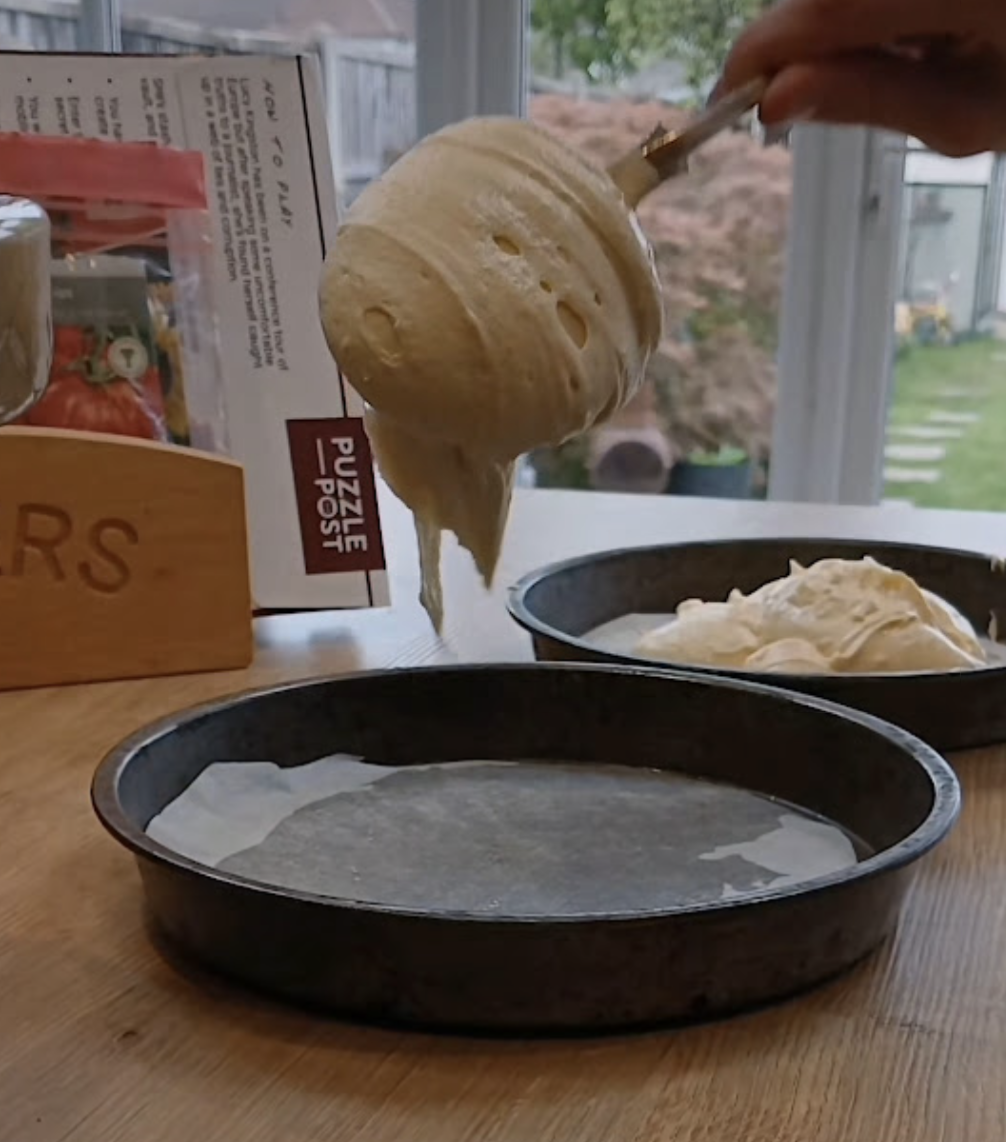 Child adding cake mixture in a real kitchen while using ClearCook-style visual cooking prompts