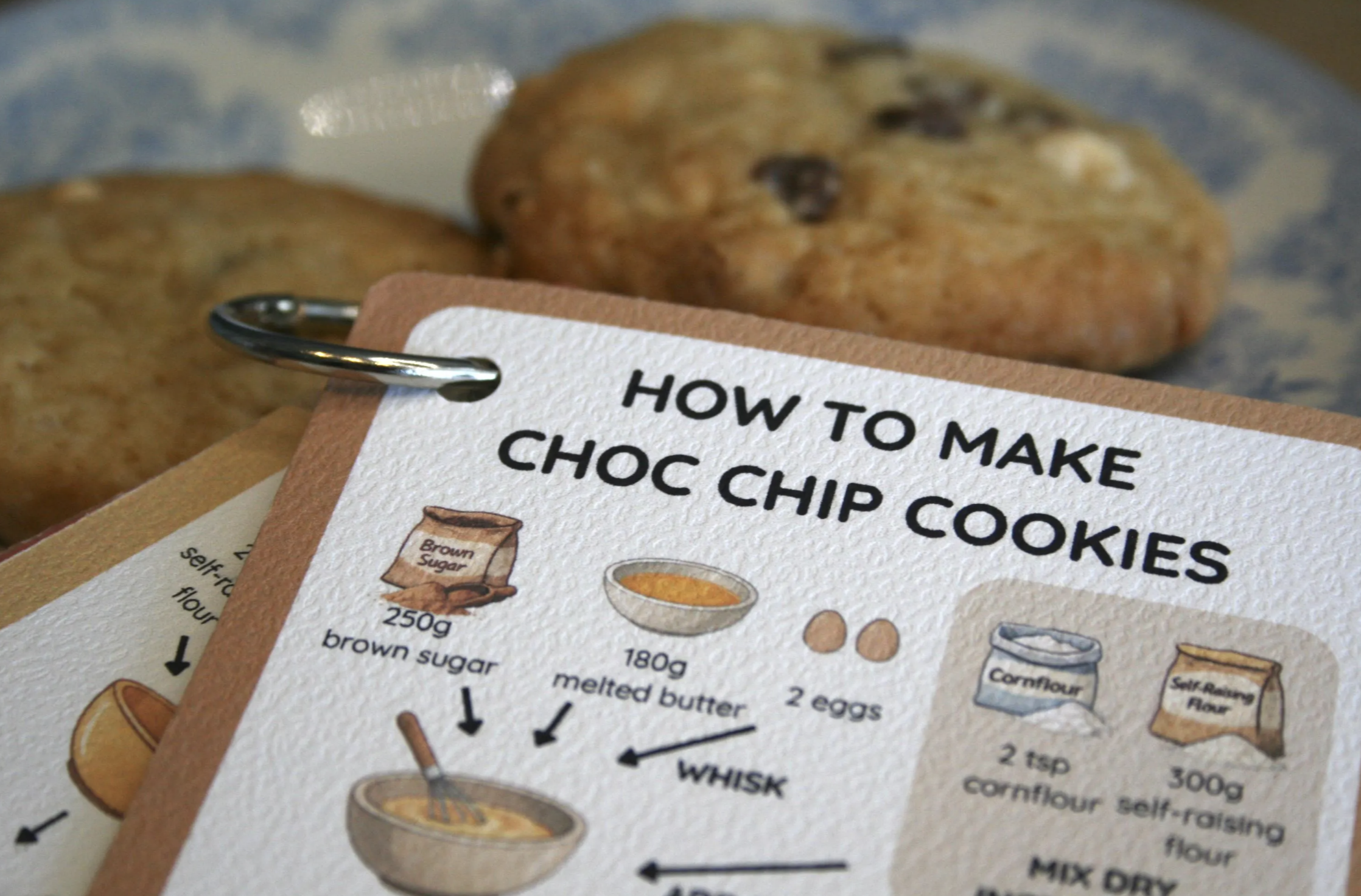 Early ClearCook chocolate chip cookie cards printed on paper beside finished cookies
